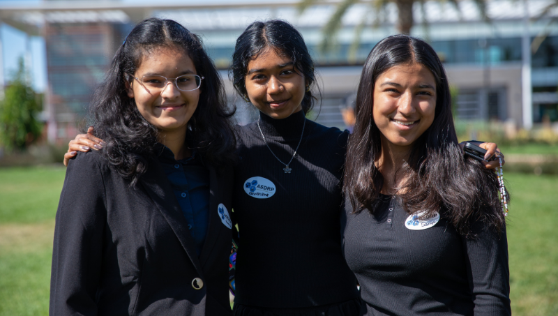 Three students smiling