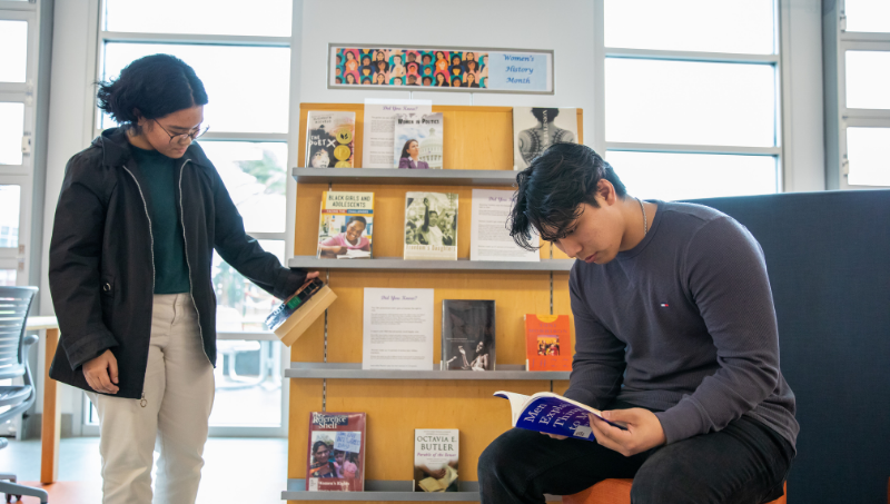 Two students looking at books