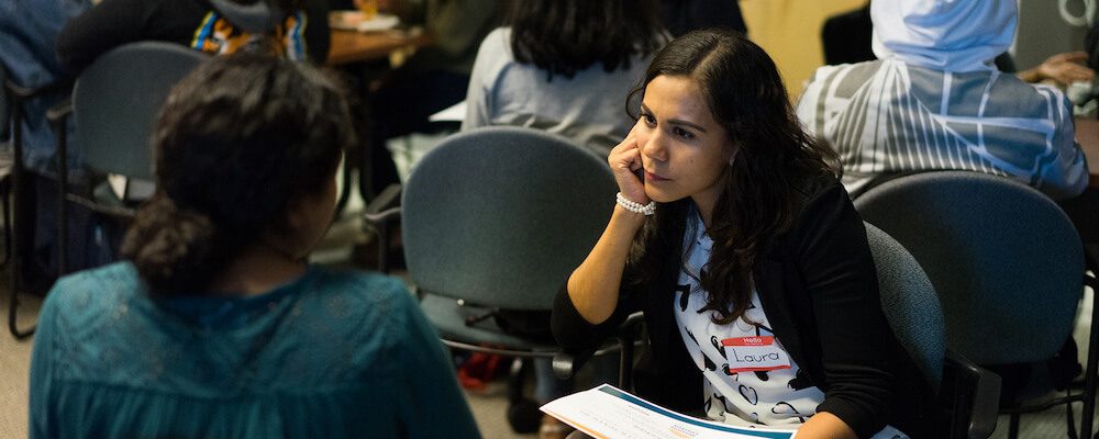 Students speak to each other in a college cafeteria.