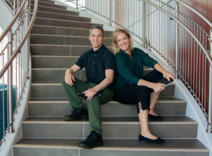 Kevin and Jeanine Flores sit on stairs on the Mission College campus.